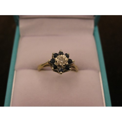 42 - 9ct Gold Ring Central Diamond, surrounded by 8 Sapphires 2.3gm size L/M