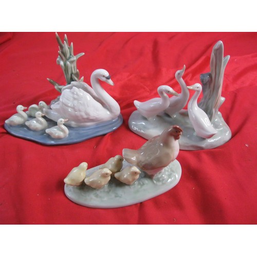 121 - Two Nao and one Lladro figures of birds comprising a Lladro Swan with cygnets #5722, Nao geese and a... 