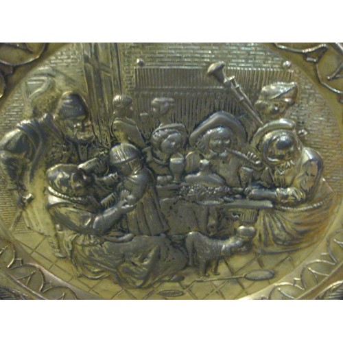 155 - Large circular brass tray or platter embossed with an Elizabethan tavern scene, diameter about 72cm