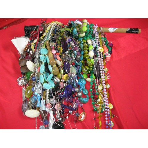 166 - A large selection of 100+ costume jewellery necklaces strung on a wooden pole, some vintage included... 