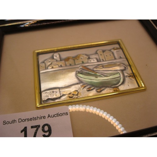 179 - A pair of embossed and tinted white metal pictures - road and houses and boats at quayside, each wit... 