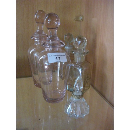 17 - A pair of pink glass dressing table bottles with spherical stoppers (height 20cm, good condition but... 