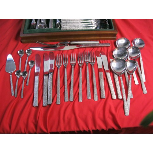 62 - A canteen of Viners Studio stainless steel cutlery with bark finish handles. Originally a six-settin... 