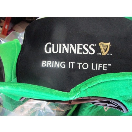 284 - A tray of pub promotional items including St Patrick's Day items to include T shirts, Hats and a ban... 