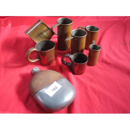 162 - An assortment of brass measures in various sizes, plus a leather bound glass and pewter hip flask