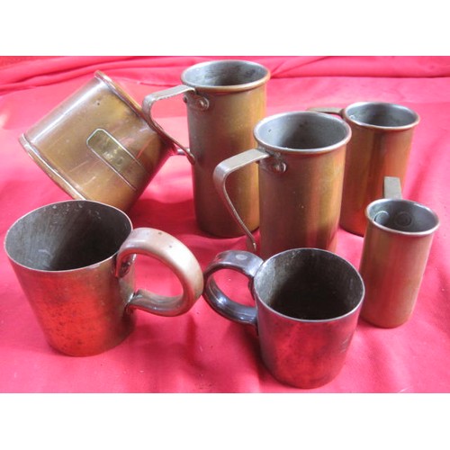 162 - An assortment of brass measures in various sizes, plus a leather bound glass and pewter hip flask