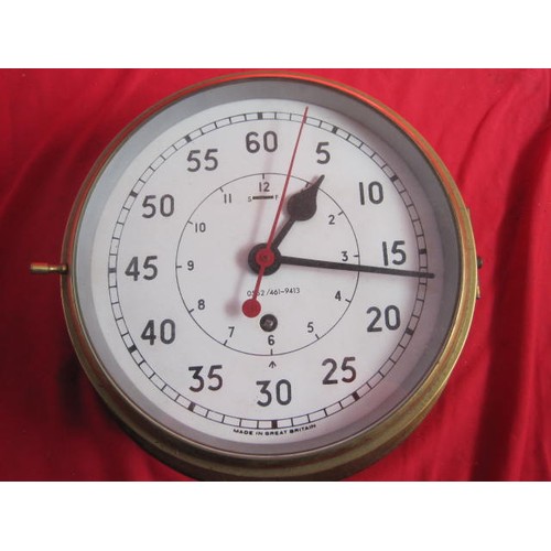 167 - A large brass WW2-era Royal Navy ship's bulkhead clock, marked with the 'crow's foot' of the Admiral... 