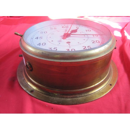 167 - A large brass WW2-era Royal Navy ship's bulkhead clock, marked with the 'crow's foot' of the Admiral... 