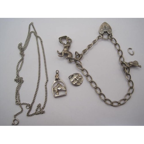 8 - A silver charm bracelet with Four charms a Horse,flying witch,smiling sun face and a Horses head alo... 