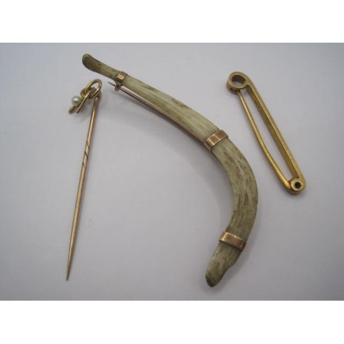 21 - A bone brooch with an unmarked  possible gold mount along with another 9ct bar brooch and a tie pin ... 