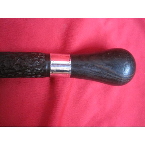 38 - A late Victorian silver collared carved ebony walking cane, believed of Indian origin