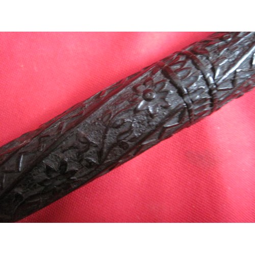 38 - A late Victorian silver collared carved ebony walking cane, believed of Indian origin