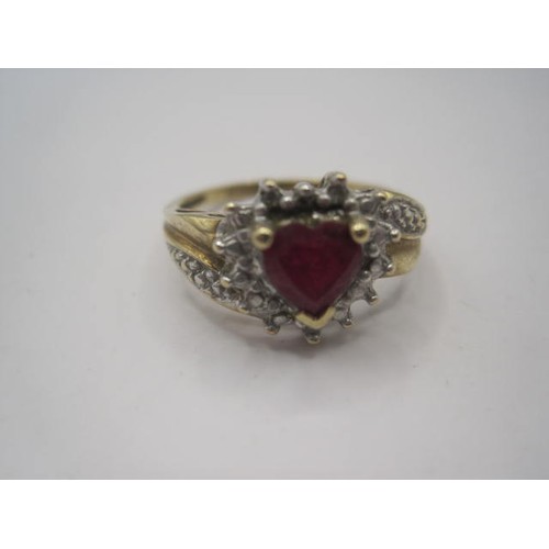 37 - A 9 carat gold ring set with a heart shaped stone of some size, likely a ruby, ring size O/P, approx... 