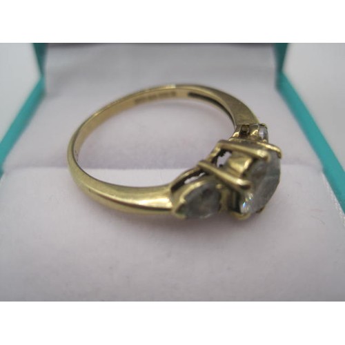 40 - A 9 carat gold ring set with 3 cubic zirconia clear stones, all of which would benefit from a polish... 