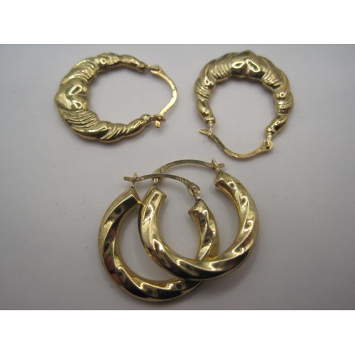 48 - Two pairs of gold hoop earrings, one with heart decoration, approx weight 1.24g