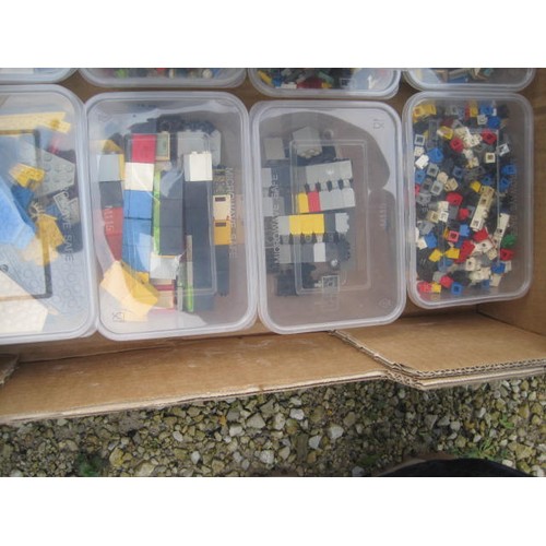 200 - Assorted Lego bricks and components contained in ten tubs in a black cardboard fruit crate