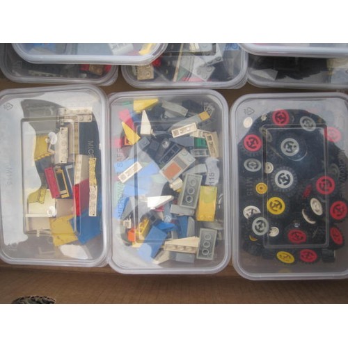 207 - Various Lego bricks and components, wheels, disks, etc, contained in 16 tubs in a cardboard banana b... 