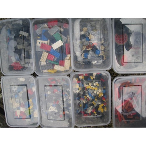 208 - Assorted Lego bricks and components contained in 21 tubs in a green plastic crate.