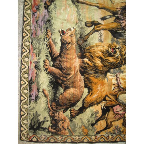 55 - An imposing woven silk wall hanging depicting a lion hunt with hunters on horses and camel, understo... 