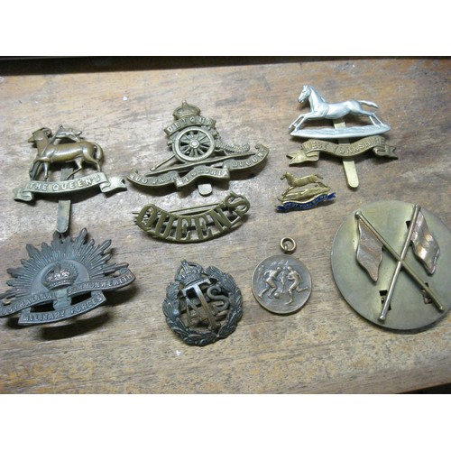 299 - A selection of WW1 & WW2 military cap badges comprising ATS, West Yourkshire Regt (+ an enamelled sw... 