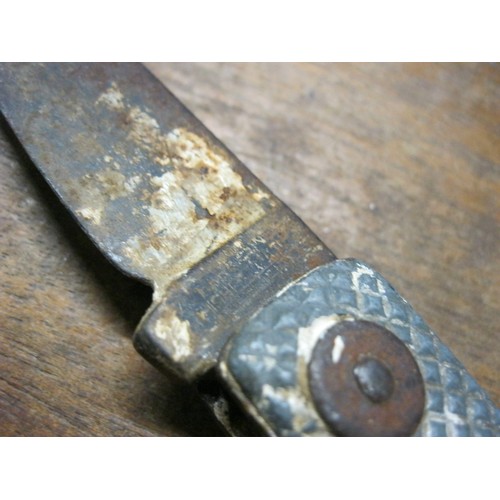 302 - A military clasp knife, one handle stamped 'F/O Waite', well worn and used but in solid condition