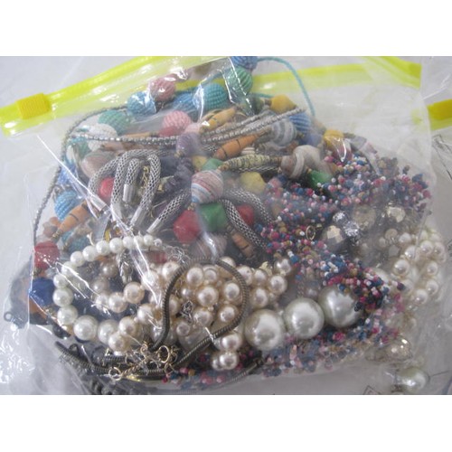 124 - A tray of assorted costume jewellery, mainly necklaces of colourful beads and simulated pearls, and ... 