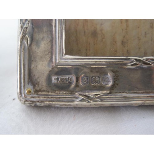 108 - A small picture frame with a sterling silver surround, hallmarked for Birmingham 1916 by Steinhart &... 