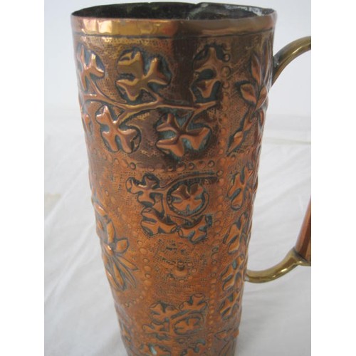 120 - An Arts and Crafts style cylindrical copper jug or measure with a brass and copper handle (a/f, unev... 