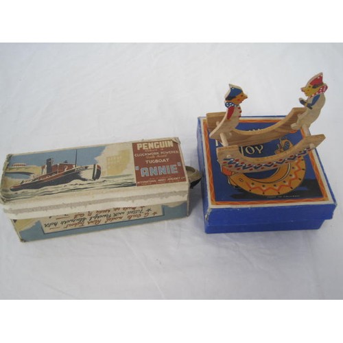 73 - TSL fully boxed wooden rocking horse along with a Penguin Clockwork Tugboat with box and key but mis... 