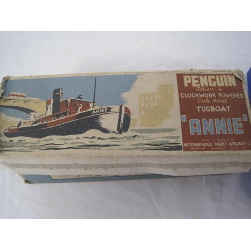 73 - TSL fully boxed wooden rocking horse along with a Penguin Clockwork Tugboat with box and key but mis... 