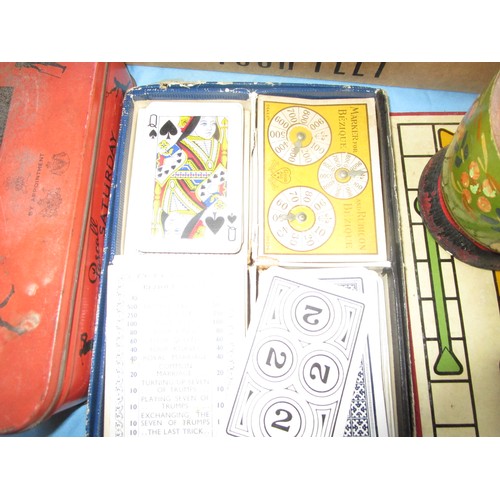 241 - A selection of vintage cards and card games including a dice shaker and various boards .Also in this... 