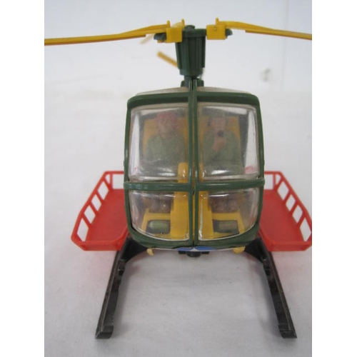 283 - A vintage Britains Bell helicopter with figures inside and winch to underside, in good order