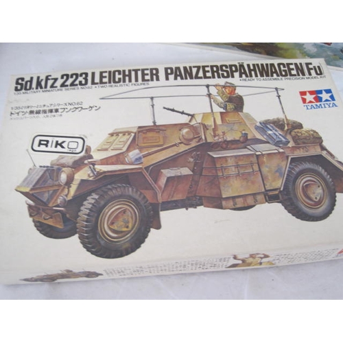 284 - Three military model kits, all appear complete but not checked, and a shoebox of Revell modelling pa... 