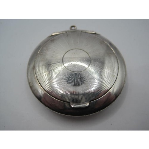 200 - A silver compact with engine turned finish to front - possibly a snuff- or pill-box - with fob hoop.