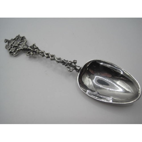 28 - An antique silver continental birthing spoon with highly decorated handle featuring a ship at its te... 