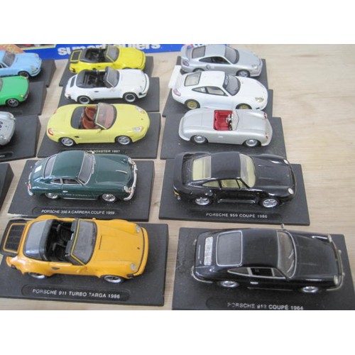 298 - A collection of twenty-one DeAgostini models of Porsche cars, including 550 RS Spyder 1955, 911 RS C... 