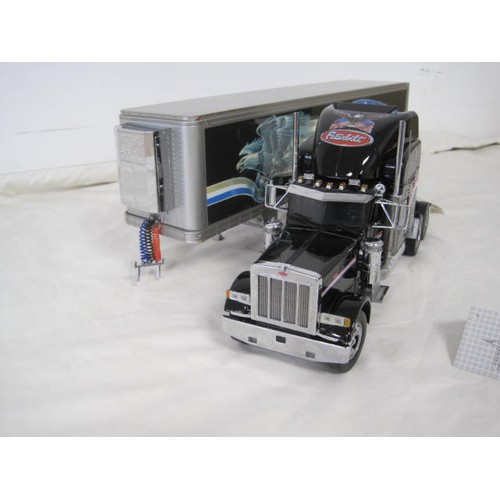 310 - Franklin Mint Precision Models Peterbilt model 379 tractor and refrigerated trailer. With labels, ve... 