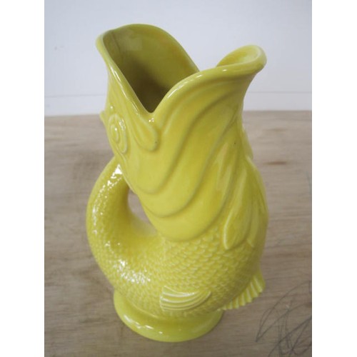 121 - A Wade glug jug in yellow glaze, height 22cm, the base marked GLUGGLE JUG WADE STOKE ON TRENT ENGLAN... 