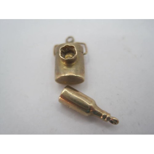 54 - Two 9 carat gold charms with British hallmarks - a bottle and  a lantern, combined weight about 1g. ... 