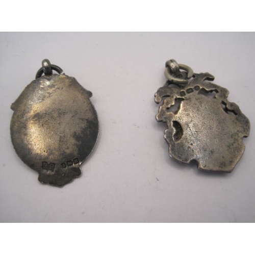 22 - Two silver medallion fobs - the first with a gilt vacant escutcheon, about 3.5cm x 2.4cm, 10g, and m... 