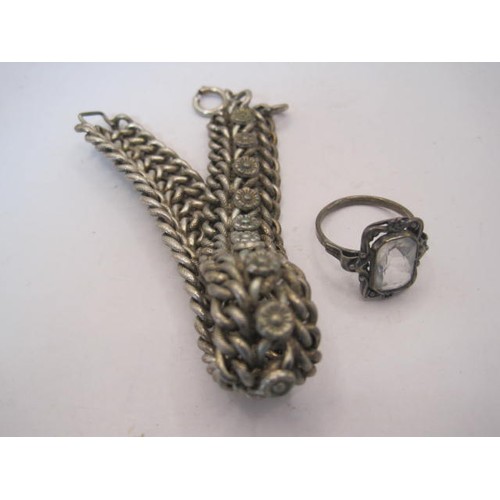 27 - A silver bracelet with triple links and foliate motifs, and an imported silver dress ring. The brace... 