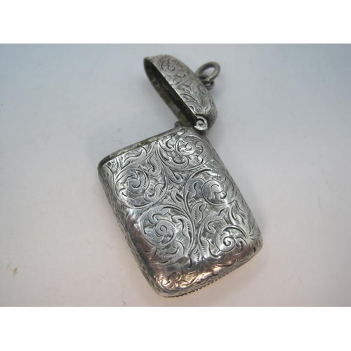 93 - Silver vesta with foliate engraving all over and a diagonal reserve to one side, 4.8cm x 3.2cm exclu... 