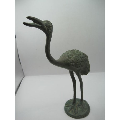 134 - A pair of verdigris bronze birds, perhaps storks or herons, on round bases, heights 26cm and 25cm