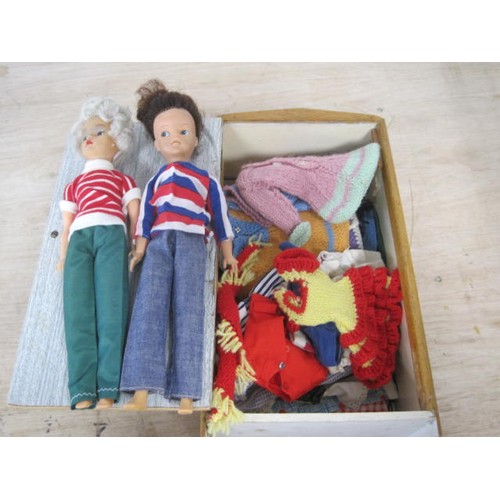 65 - Two Sindy Dolls in a wooden wardrobe along with a selection of clothing both original and homemade e... 