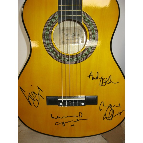 194 - An acoustic guitar signed by all 4 members of the group Oasis, boxed, with certificate of authentici... 