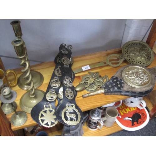 136 - A selection of horse brasses along with a mini bed warmer ,two candlesticks and a fire blower .