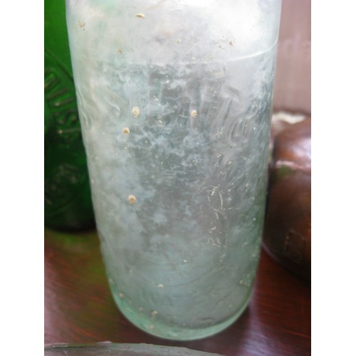 141 - A selection of Green, Brown and Clear vintage advertising bottles along with a ceramic version, incl... 