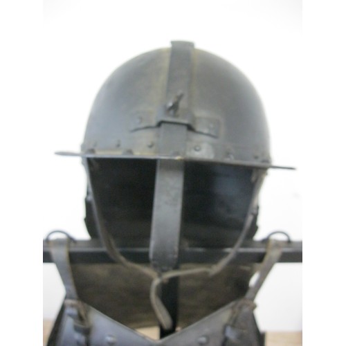 230 - A reproduction Roundhead Helmet and Infantry Cuirass mounted on a wooden stand, the pair in good ord... 