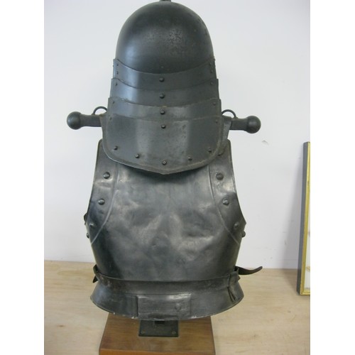 230 - A reproduction Roundhead Helmet and Infantry Cuirass mounted on a wooden stand, the pair in good ord... 