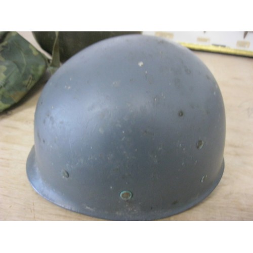 227 - A post-WW2 US M1 Helmet with liner, chinstrap and camouflage cover, in good order